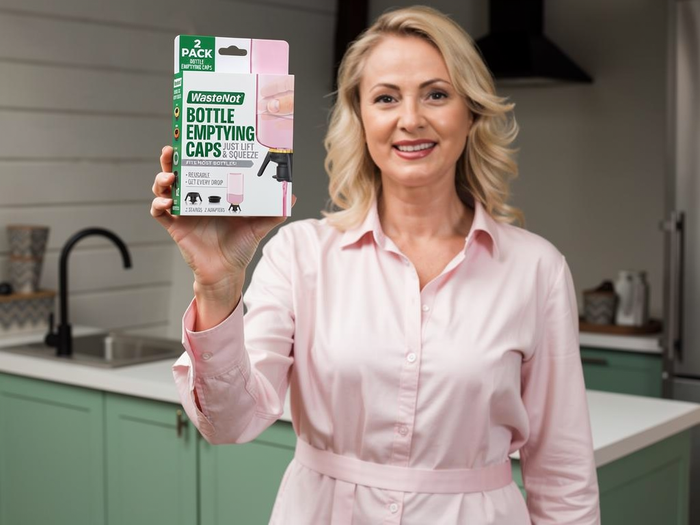 Founder portrait (female), warm and genuine, holding the WasteNot Cap in a normal home — looks like the customer, not a corporate headshot